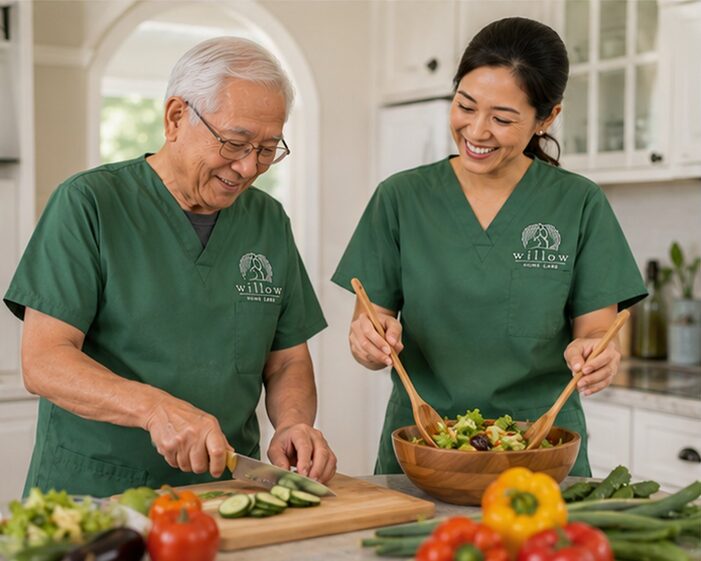 Caregiver helping senior woman prepare a fresh salad